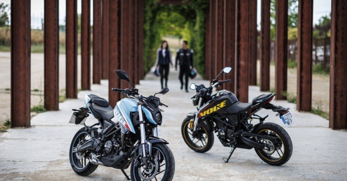 a motorcycle parked on a rocky river bank